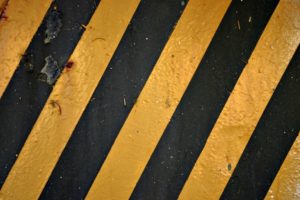 Precarious, yellow and black road stripe